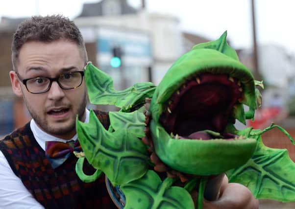Luke Palmer, who is playing Seymour, pictured with the murderous Audrey II                                          L24709H14
