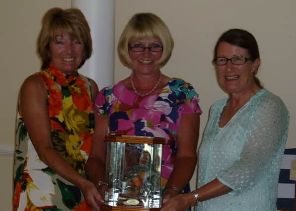 Cottesmore Golf Club Ladies winners Laura Marsh and Carol Bauckham
are presented with the trophy by Lady Captain Christine Knight SUS-140721-174725002