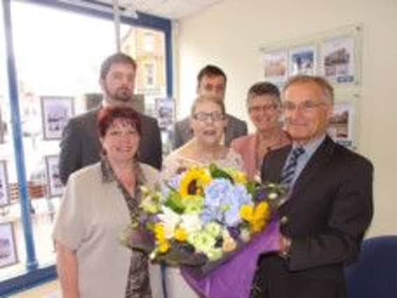 Long-serving tanant June Hookway receives a bouquet of flowers from Shuttleworths SUS-140728-151226001