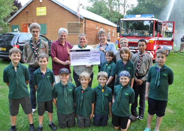 HENFIELD cheque for  Scout Hut fund. L-r Benjamin Jennings, young leader, Eric Williams, chairman of Clarkes Mead Trust, Paula Flower,group scout leader, and Nick Cryer, of Gardens and Arts. Pic Mike Beardall SUS-140729-102111001