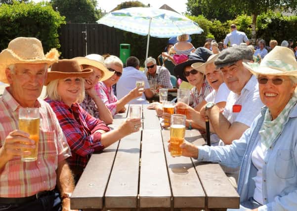 WH 250714  Cheers: Members of the Phoenix Over 50s raise their glasses in the sunshine