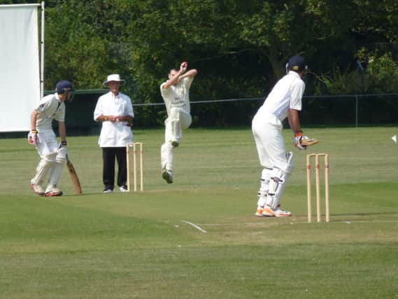 Craig Pierce bowling for Rye against Slinfold. Picture by Simon Newstead (SUS-140727-112300002)
