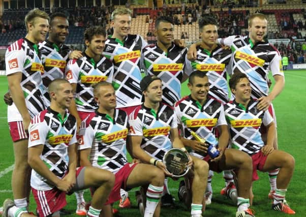 Jack Maslen (front row, far left) and James Chisholm (back row, far right) celebrate with their Harlequins team-mates after winning Group C of the Premiership 7s.