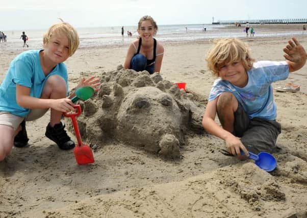 Talented trio George Roberts, Macie Sim and Nathan Robert finish off their sandy creature, below (L31821H14) and there was something fishy about Esme McCartney and Daisy Kendall mermaid, above (L31828H14)