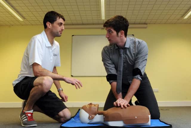 Gazette chief reporter Tom Cotterill, above, used his first aid skill to give CPR. Pictured with Mike Mole, left