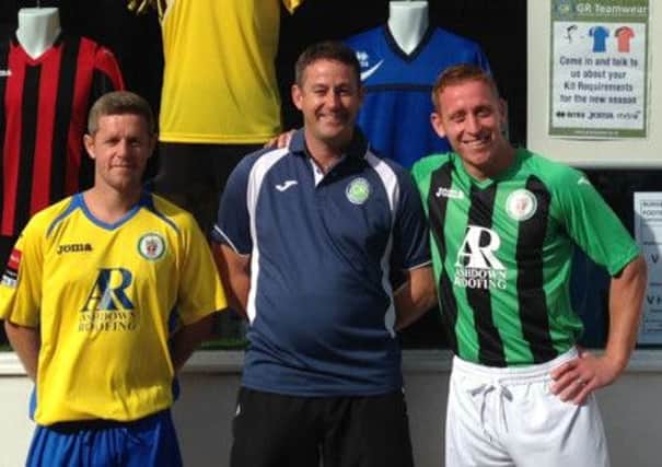 Pat Harding (Green & Black kit), Ian Green from GR Teamwear and Darren Budd (Yellow & Blue) in the new kits outside the Shop in Church Road.