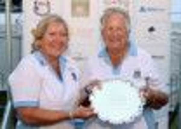Yvonne Woodcock and Wendy Davies lift the womens senior pairs trophy
