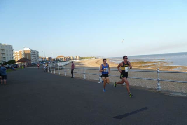 Nick Duggan and Max Thomas vie for the lead in the final Bexhill 5K Seafront Series race. Picture by Simon Newstead (SUS-140108-103809002)