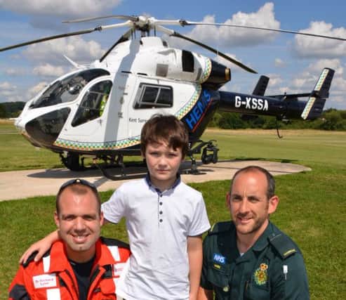 Kent, Surrey and Sussex Air Ambulance doctor Richard Lyon, Harry Leake and SECAmb paramedic Mark Griffiths. Harry was hit by a motorbike last year and nearly died. SUS-141108-082731001