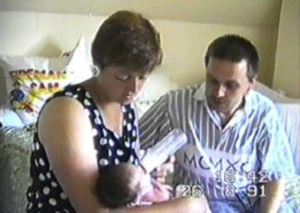 This shot shows the mystery mother and father with their new-born baby SUS-140725-151457001