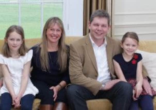 Tim Farmer with his wife and two daughters