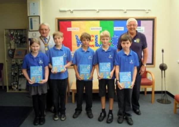Club President John Menlove and Rotarian Patrick Leake join some of the children from Park Mead Junior School after presenting their dictionaries SUS-141208-164049001