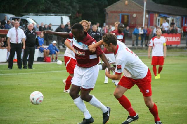 Hastings United striker Ade Olorunda (left) tries to take on a Whitstable Town defender. Picture courtesy Terry S. Blackman