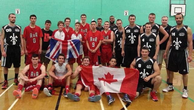 The ADA Bexhill Giants and Toronto Knights on court together after the In The Dark International Basketball Tournament at Bexhill Leisure Centre