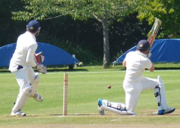 Harry Finch sweeps for four during Hastings Priory's victory over Cuckfield. Picture by Simon Newstead (SUS-140816-231613002)