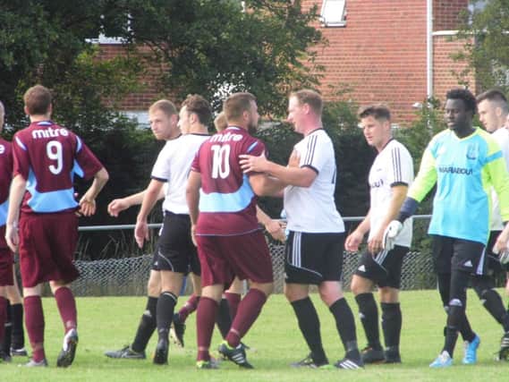 Little Common and Bexhill United get to grips with each other during a thrilling local derby at the Recreation Ground yesterday. Picture courtesy Paul Field