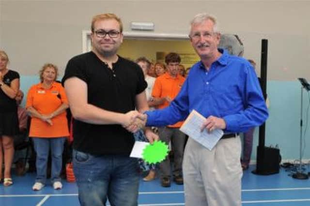 Alfie Parker receives his grant funding from Worthing Homes chairman Chris Polden SUS-140819-154634001