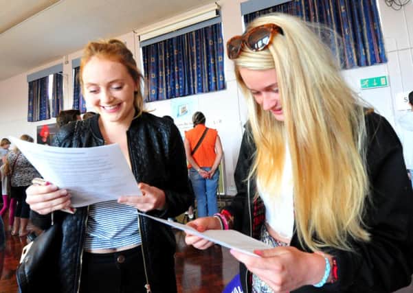 21/8/14- Pupils at Claverham Community College in Battle celebrating their GCSE results.  Sophie Bridger and Brandy Rook SUS-140821-124429001