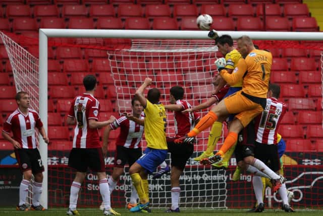 Sheffield United  v Crawley Town  23.8.14
 Pic : Martyn Harrison
Joe Walsh & Brian Jensen  - Crawley challenge for the ball in the dying minutes

© copyright : Blades Sports Photography SUS-140824-160858002