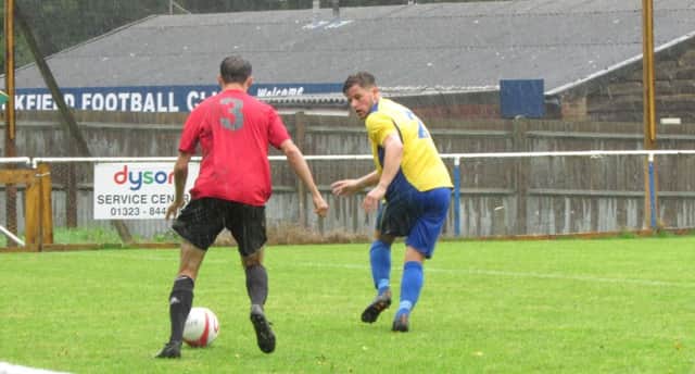 Bexhill United full-back Anthony Cooper keeps a close eye on an AFC Uckfield opponent. Picture courtesy Mark Killy