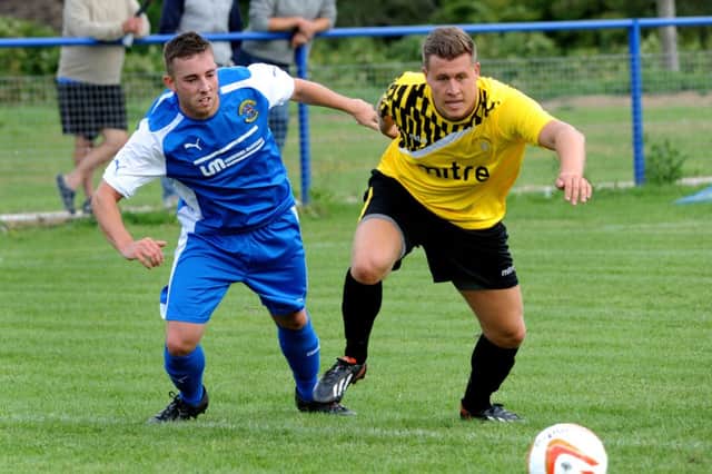 Martin Denny (right) tussles for possession during Little Common's 4-3 defeat away to Haywards Heath Town on Saturday. Picture by Steve Robards (SUS-140823-212422001)