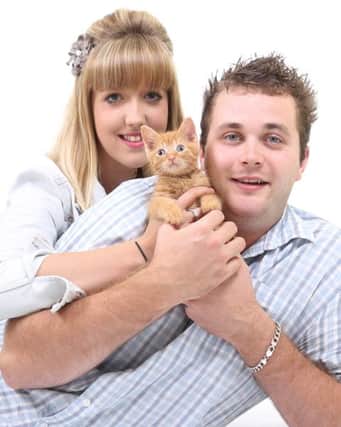 Fugly the kitten, who has become a Youtube sensation. Pictured with owners Lisa Madgwick and Matt Rann SUS-140827-092950001
