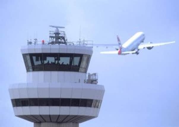 Gatwick Airport, control tower with aircraft in flight in background, August 2004.