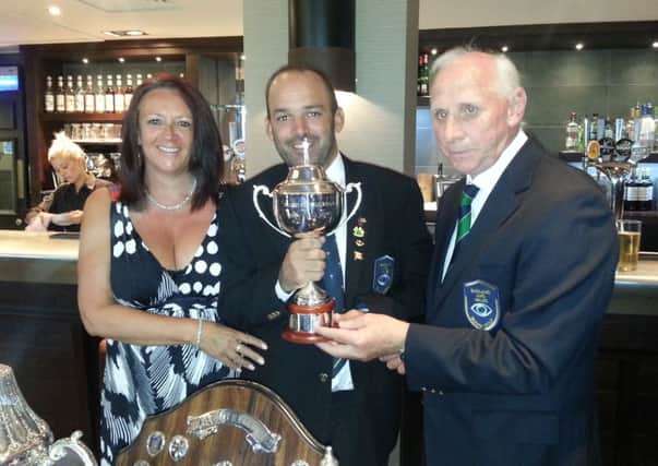 Andy Gilford, pictured with wife, Melanie, is presented with the order of merit championship by England and Wales Blind Golf captain Barry Ritchie.