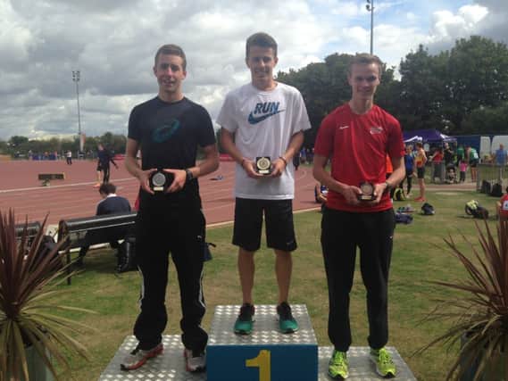 Ross Skelton on top of the podium after winning the 5,000m at the Track & Field Inter-Counties Championships