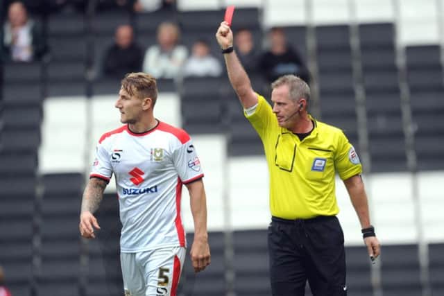 MK Dons' Kyle McFadzean is shown the red card against his old club Crawley Town (Pic by Jon Rigby) SUS-140830-182849002