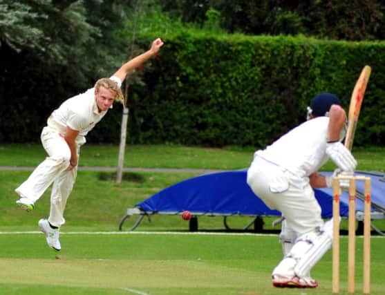Dean Crawford bowling for Bexhill against East Grinstead in the Sussex Premier League yesterday. Picture by Steve Hunnisett (SUS-140830-184402002)
