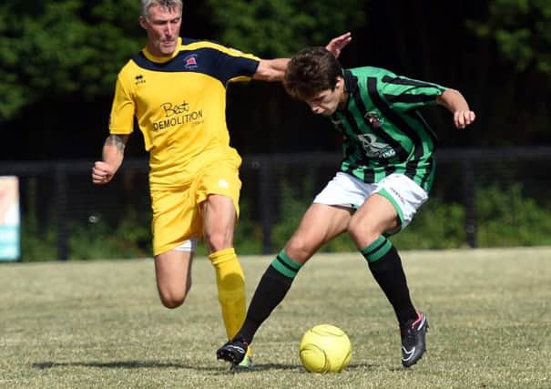Football. Sussex League. Burgess Hill V Eastbourne Brough friendly. Action from the match.  Burgess Hill's Lee Harding takes the ball from  Eastbourne's Jay Lovett .   Picture: Liz Pearce 260714. SUS-140726-200949008