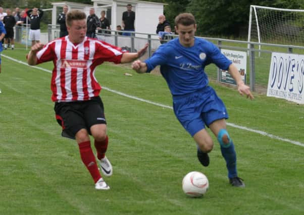 Dave Brown Horsham YM FC (blue) pictured right against Redhill. Picture by Clive Turner