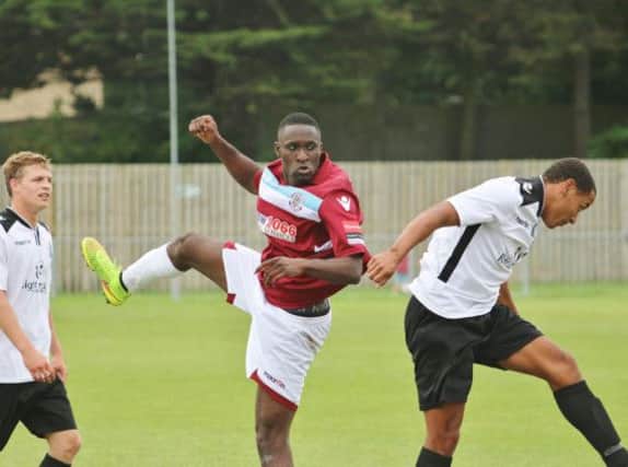 Hastings United midfielder Olalekan Bankole (centre) tussles with Wes Tate (right) during the first team's FA Cup victory over Eastbourne United AFC on Saturday. Picture courtesy Joe Knight