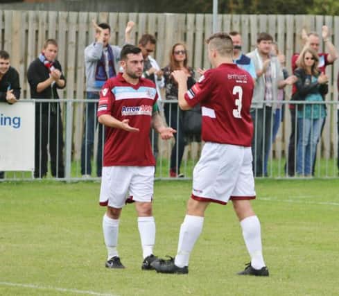 Hastings United captain Frankie Sawyer (left) celebrates with Sam Cruttwell after scoring in last weekend's FA Cup preliminary round victory away to Eastbourne United AFC. Picture courtesy Joe Knight
