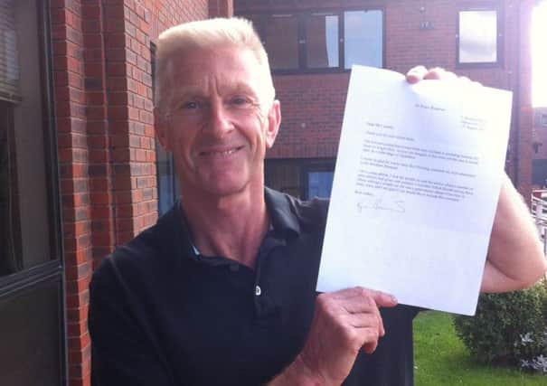 Cliff Comber holding the letter he received from Sir Roger Bannister
