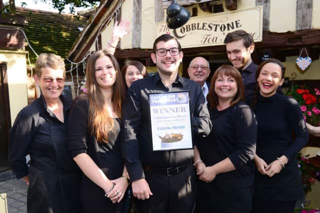 Owner Eddie Woodward, centre, and staff with the Herald & Gazette Café of the Year certificate D14361475a