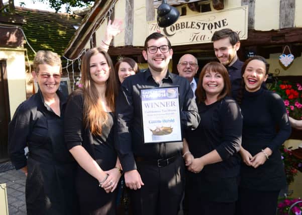 Owner Eddie Woodward, centre, and staff with the Herald & Gazette Café of the Year certificate D14361475a