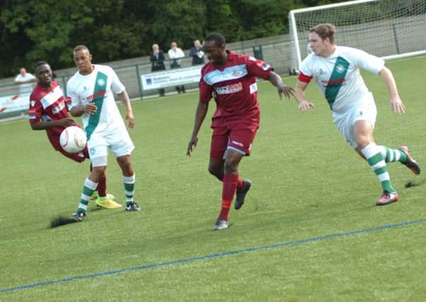 Hastings United match-winner Ade Olorunda tries to hold off a Whyteleafe defender. Picture by Simon Newstead (SUS-140915-084225002)