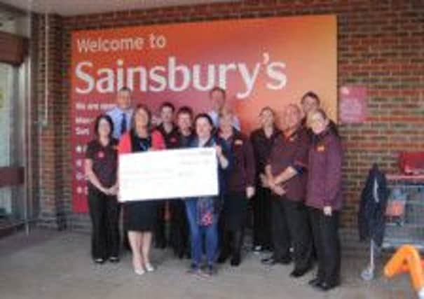 Sainsbury's Pulborough present cheque to Sussex Air Ambulance SUS-140915-150026001