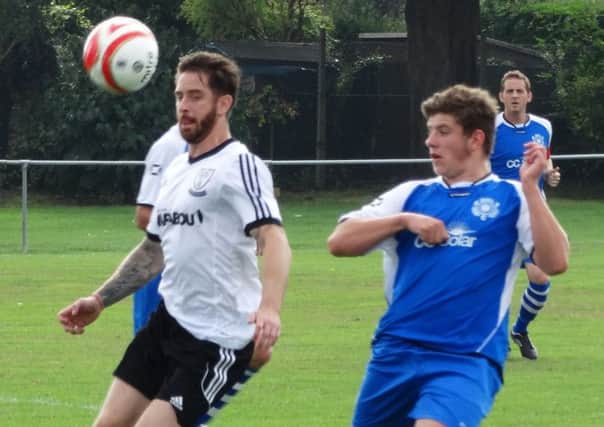 Andy Garman (left) in action for Bexhill United against Rustington on Saturday. Picture courtesy Mark Killy