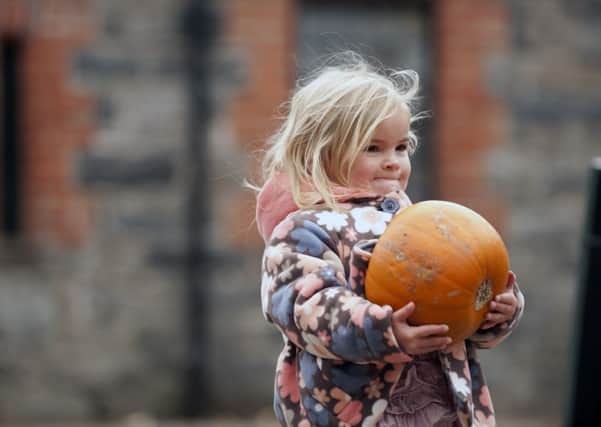 National Trust - little girl with pumpkin SUS-140922-150314001