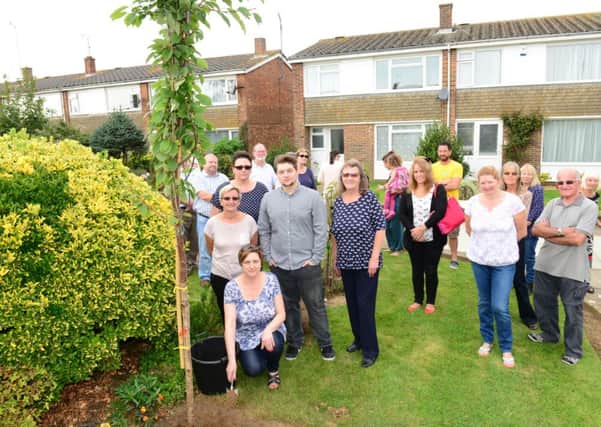 Paula Harding with family and friends planting a tree in memory of her partner, Jason Edwards D14381351a