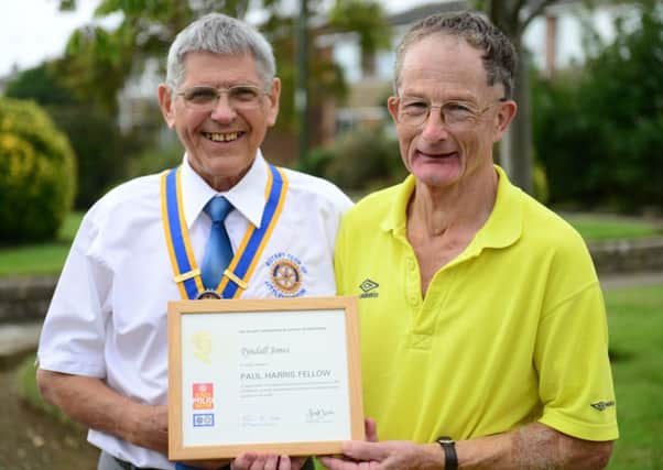 Tyndall Jones (right) received his award from Rotary president John Mitchell
