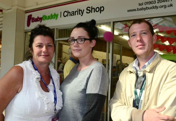 WH 230014 Babybuddy in Guildbourne Centre. Charity shop been increasingly targeted by thieves in recent weeks, most of which are pensioners. Lorraine Harman and daughter Chelsea and Steven Reader. Photo by Derek Martin SUS-140923-212557001