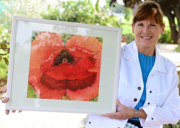 Patricia Gill with her painting donated to the Royal British Legion D14361606a