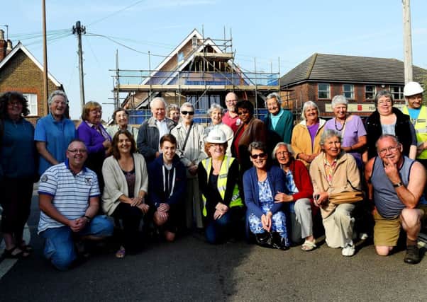 Topping out ceremony at St Andrews Church, Roffrey. Picture is Rev Kath Jones with church members. Horsham. Picture : Liz Pearce. LP220914TO01 SUS-140922-175248008