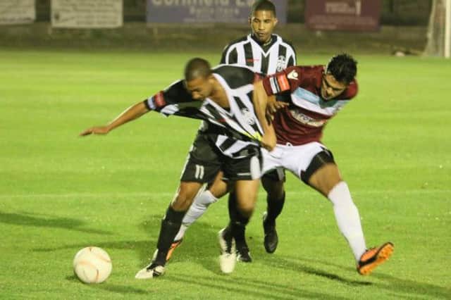 Hastings United winger Taser Hassan tussles for possession during the 3-0 defeat at home to Tooting & Mitcham United on Monday night. Picture courtesy Joe Knight