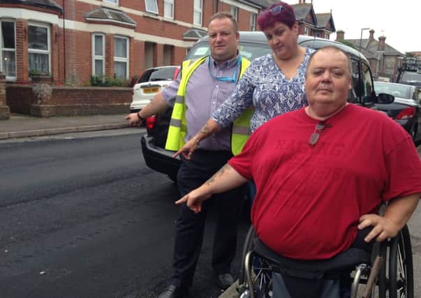 Residents in Connaught Road, Littlehampton, are furious over the state of their resurfaced road. Pictured left to right are county councillor Ian Buckland, Tracie McKay and husband Steve SUS-140110-074641001