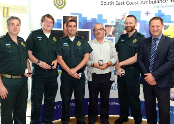 Tony Burroughs with the paramedics who saved his life